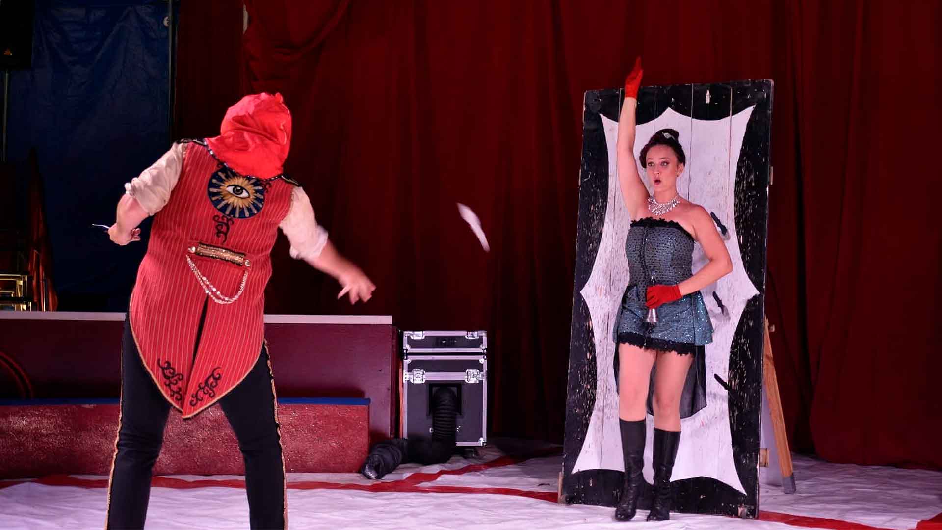 Circus Knife Throwing Act with flying knives